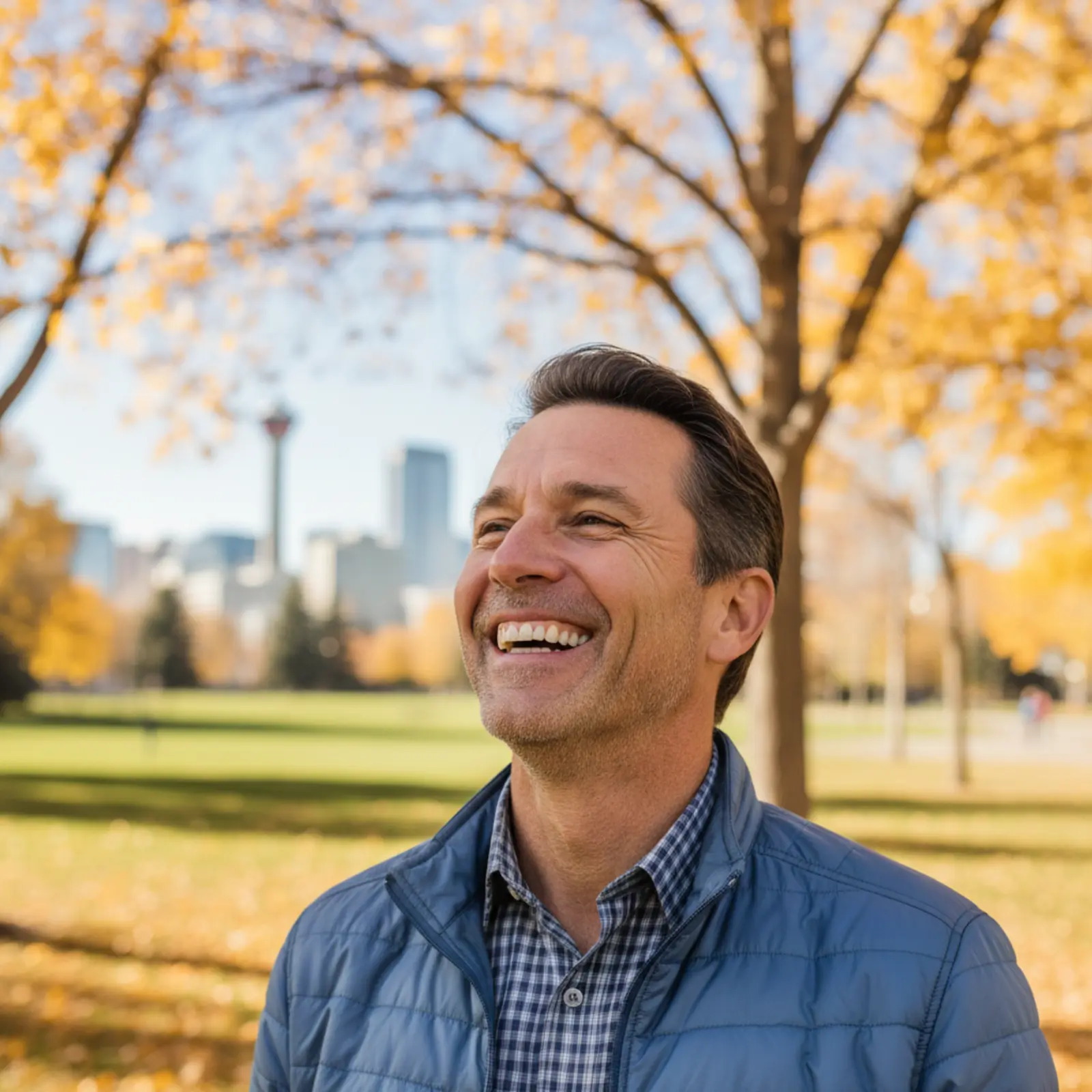 A confident man smiling outdoors in Calgary